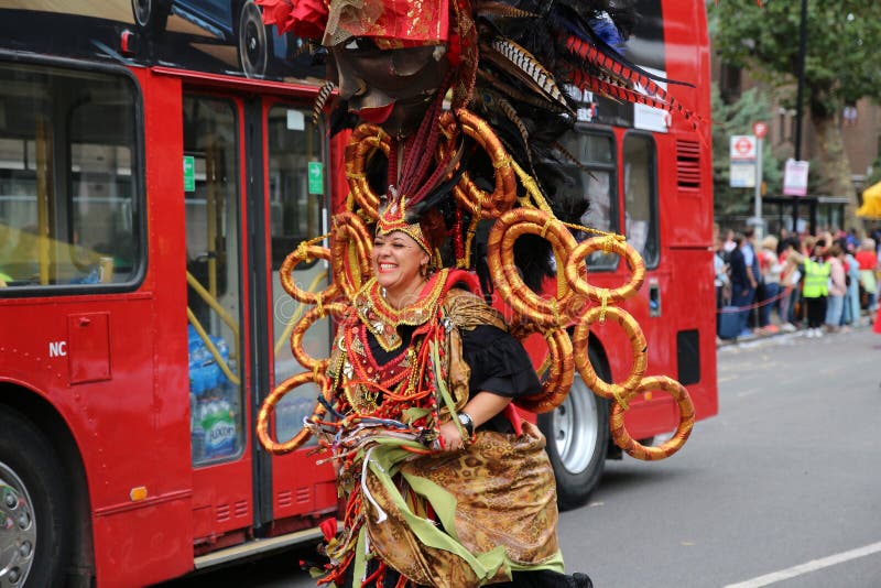 Woman in carnival costume chasing a bus, Notting Hill Carnival stock images Woman in carnival costume chasing a bus, Notting Hill Carnival stock images