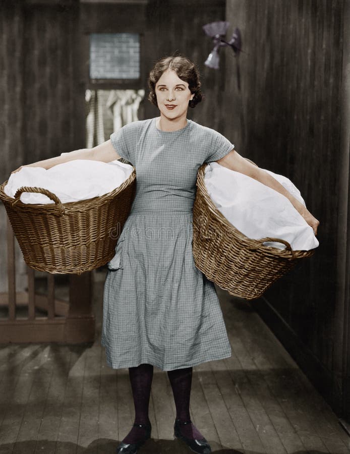 Woman carrying laundry baskets (All persons depicted are no longer living and no estate exists. Supplier grants that there will be no model release issues.)