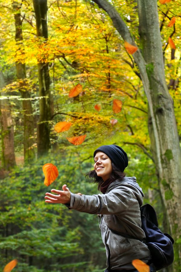 Woman is catching falling leaves