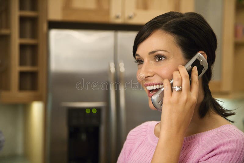 Woman on Cell Phone Smiling royalty free stock photos