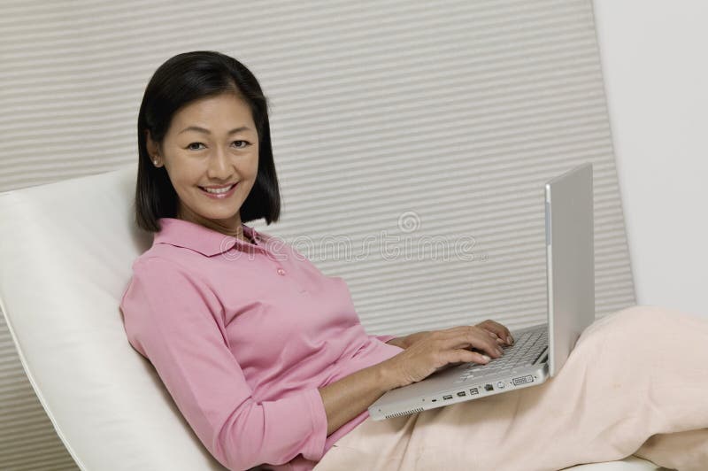 Woman in Chair Using Laptop