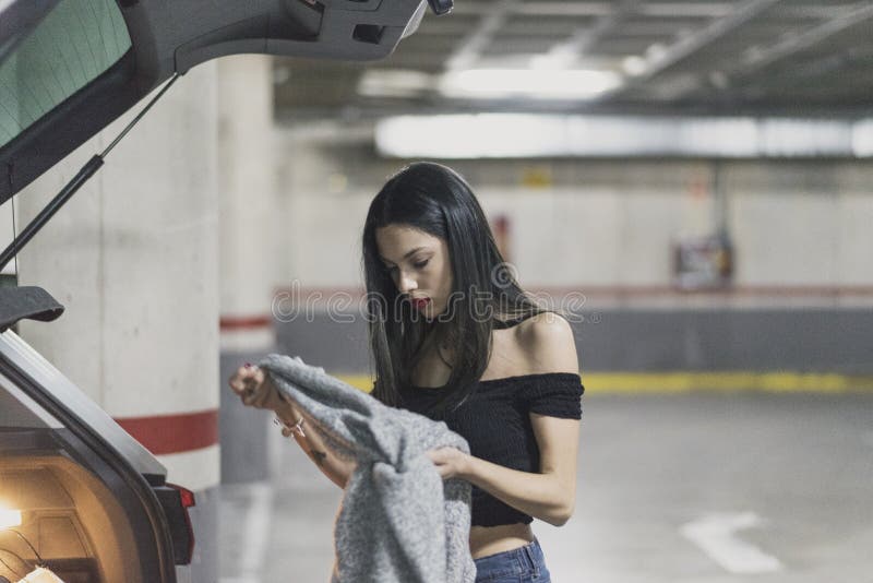 Woman changing her clothes dressing in parking royalty free stock image Woman changing her clothes dressing in parking royalty free stock image
