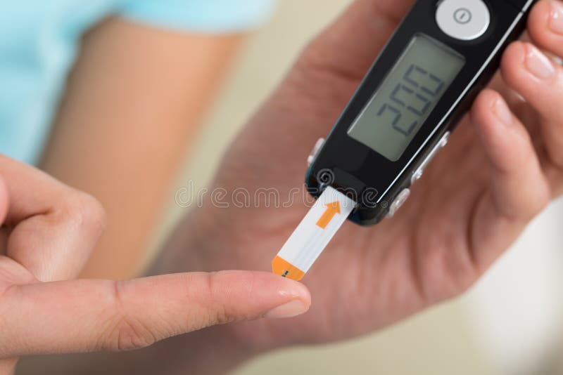Woman Checking Blood Sugar Level