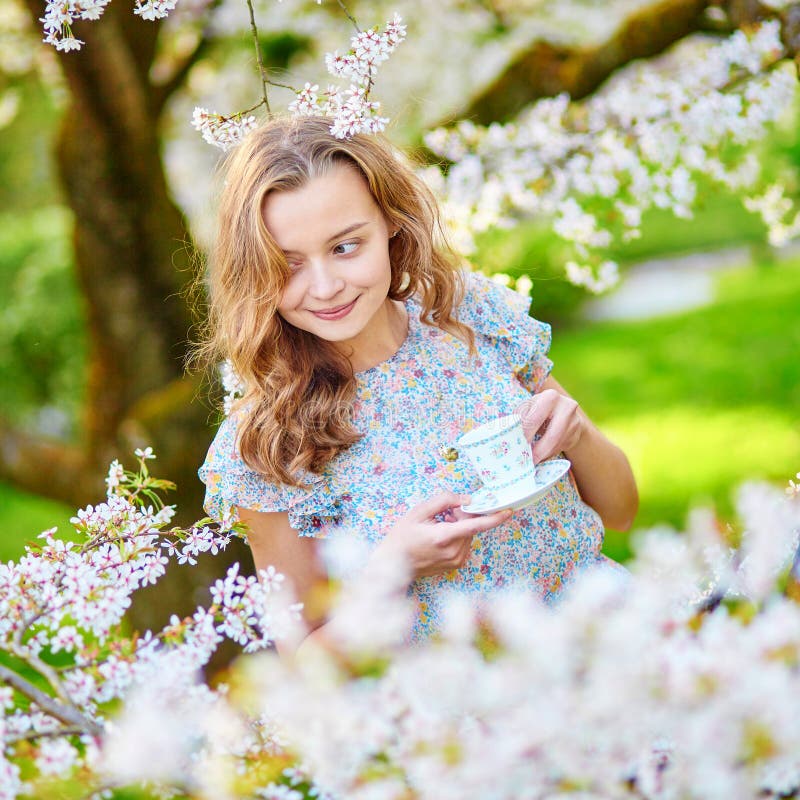 Woman in Cherry Blossom Garden with Cup of Tea Stock Photo - Image of ...