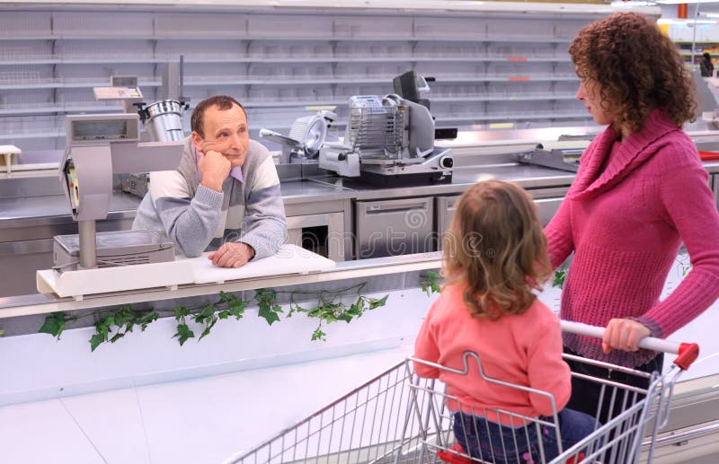 Woman with child and bored seller in shop royalty free stock images Woman with child and bored seller in shop royalty free stock images