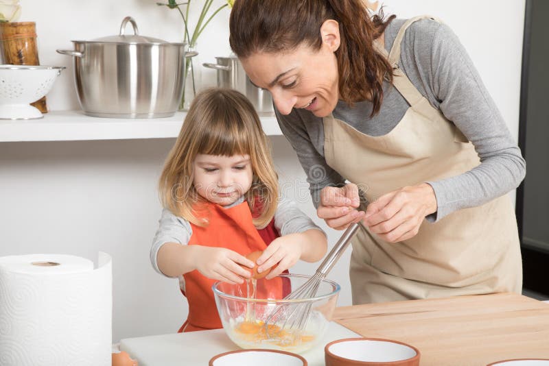 Woman and Child Cooking Breaking an Egg in Bowl Stock Photo - Image of ...