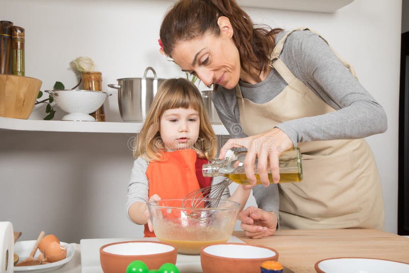 Woman and Child Cooking Pouring Oil in Bowl Stock Image - Image of chef ...