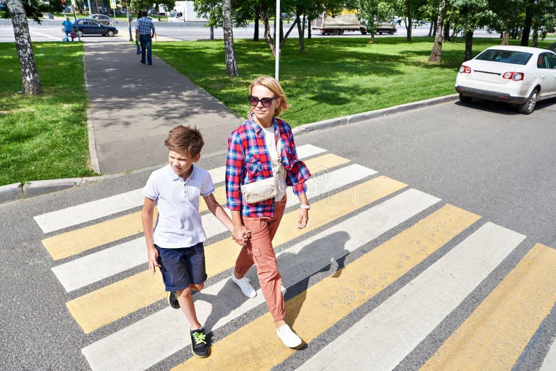 Woman and child on crosswalk street