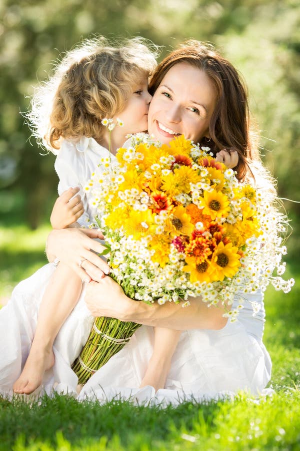 Woman and child holding bouquet of flowers stock images Woman and child holding bouquet of flowers stock images