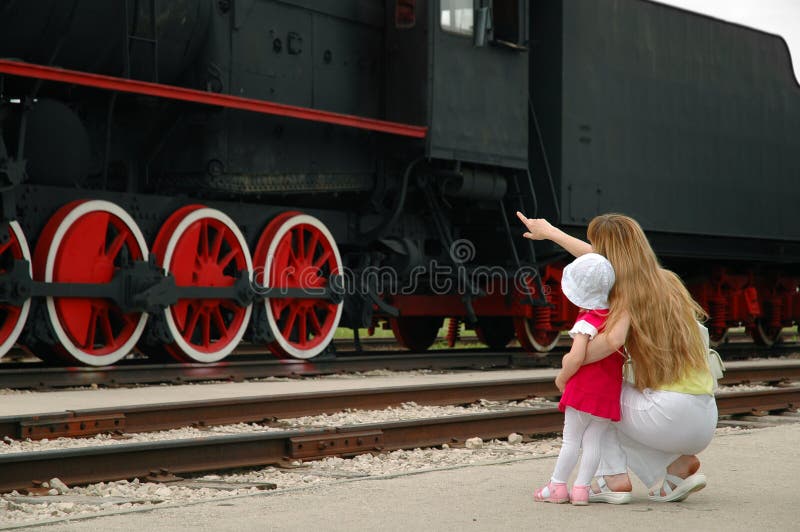 Woman and child look at locomotive