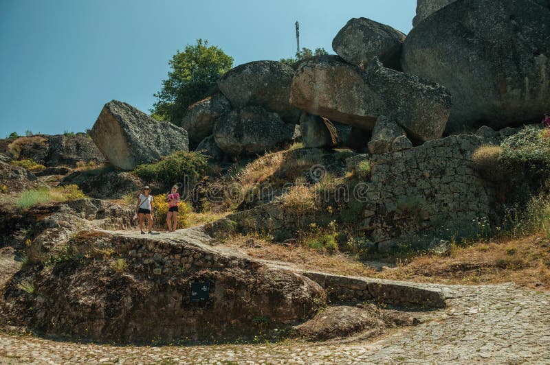 Woman and child walking by a path with rocks in Monsanto stock photo Woman and child walking by a path with rocks in Monsanto stock photo