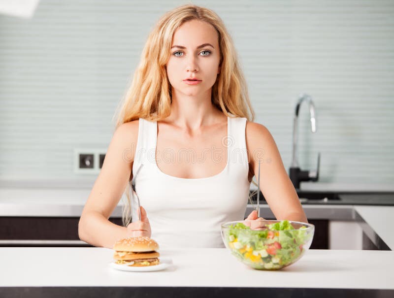 Woman Chooses between a Healthy and Unhealthy Food Stock Photo - Image ...