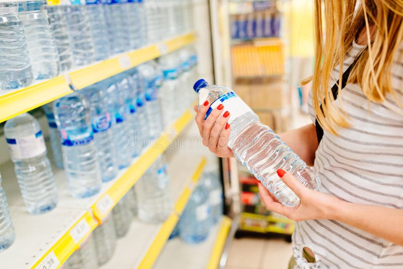 Woman choosing bottled mineral water