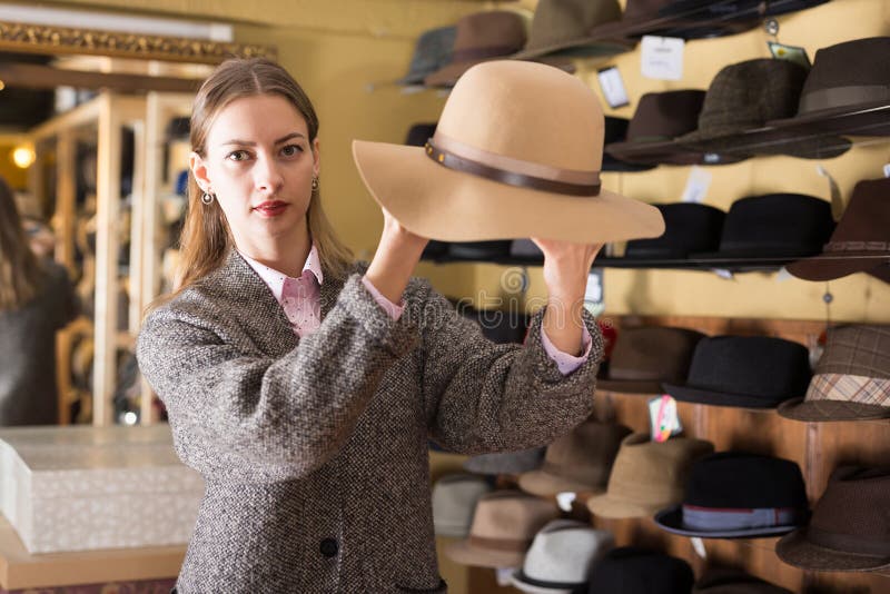 Woman Choosing Hat in Store Stock Photo - Image of classic, 2530: 208575094