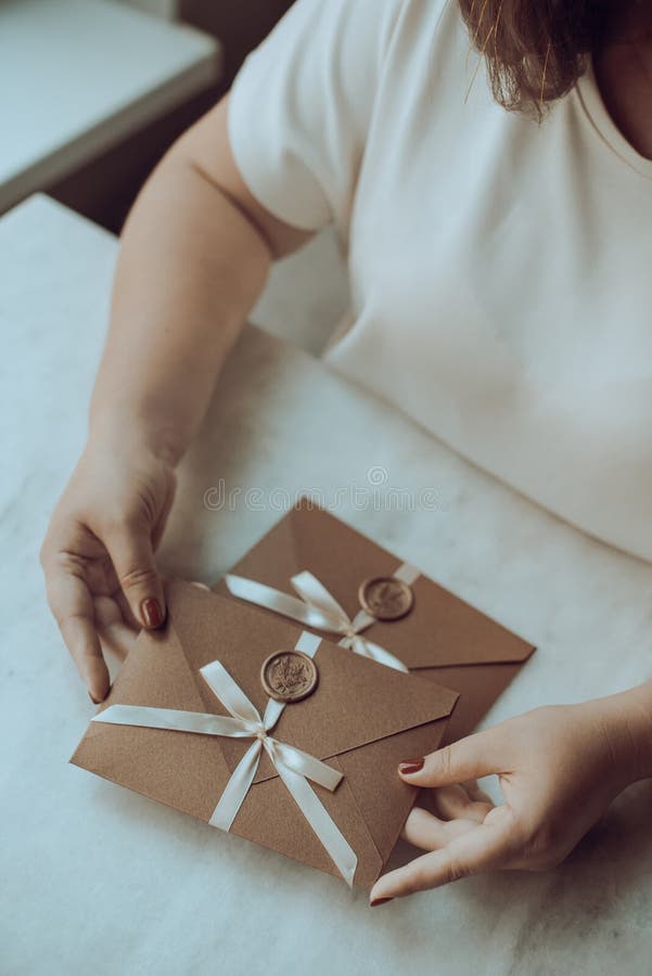 Woman Choosing an Unusual Gift Envelope Gift Certificate with Bow and Woman Choosing an Unusual Gift Envelope Gift Certificate with Bow and