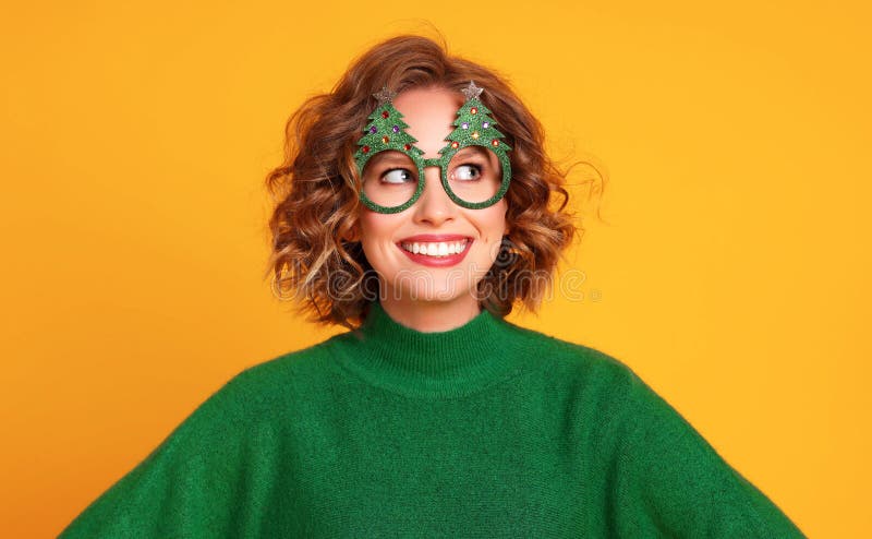 Woman in Christmas glasses smiling and looking away