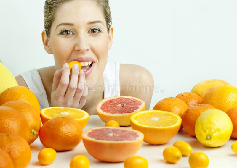 Woman with citrus fruit
