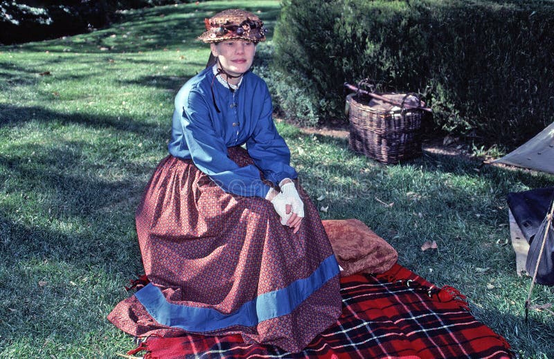 Image shows a woman reenactor in Civil War era dress. Photo taken at at Civil War reenactment show. Image shows a woman reenactor in Civil War era dress. Photo taken at at Civil War reenactment show.