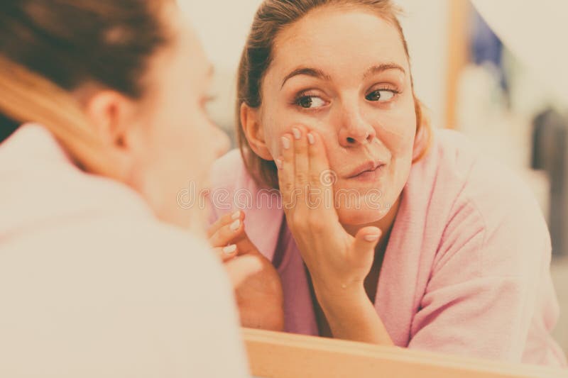 Woman cleaning her face with scrub in bathroom. royalty free stock photos Woman cleaning her face with scrub in bathroom. royalty free stock photos