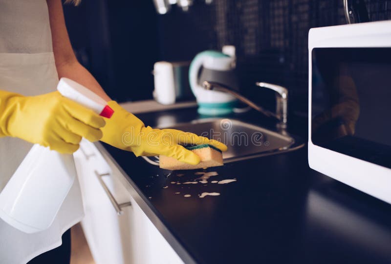Woman cleaning kitchen cabinets with sponge stock image Woman cleaning kitchen cabinets with sponge stock image