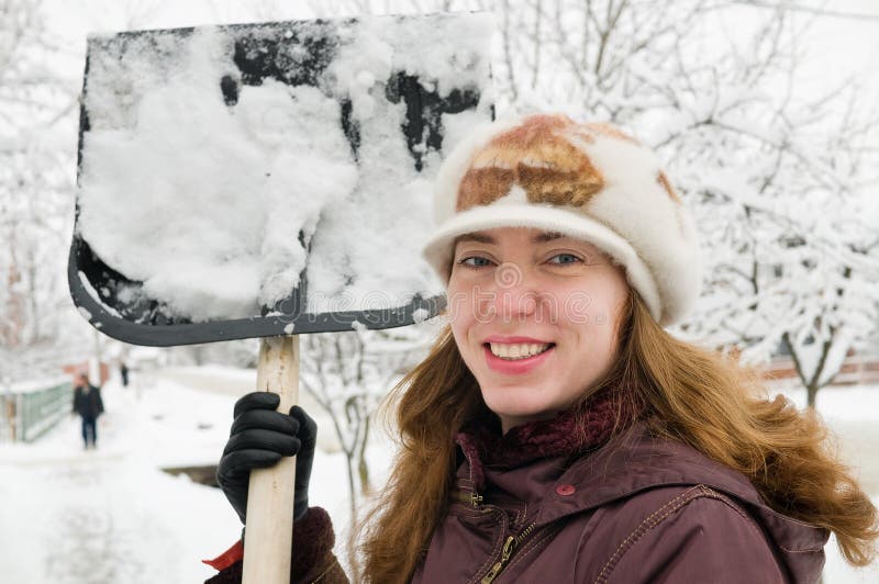 The woman cleans snow.