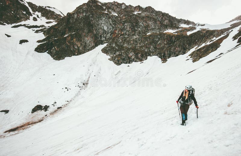Woman climbing with ice axe mountaineering Travel