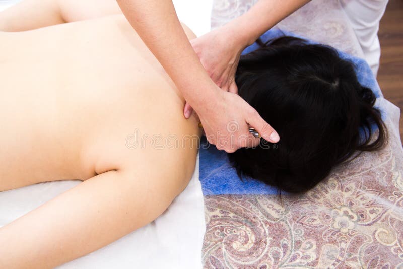 A woman in a clinic receiving a neck massage. Upper view royalty free stock photography A woman in a clinic receiving a neck massage. Upper view royalty free stock photography