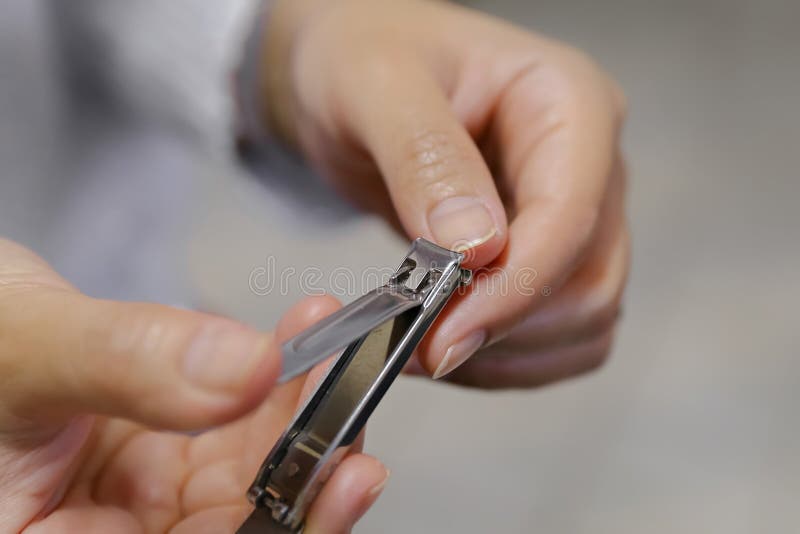 Close-up Clipper and Nail Clipping on Woman`s Hand Stock Image - Image ...