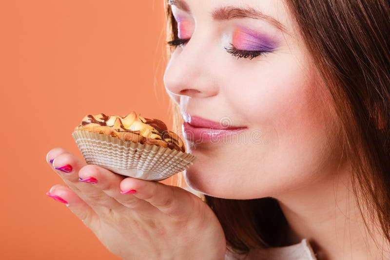 Woman closed eyes holds cake in hand royalty free stock photography Woman closed eyes holds cake in hand royalty free stock photography