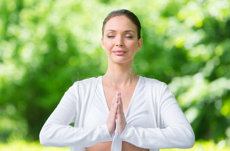 Woman with closed eyes prayer gesturing