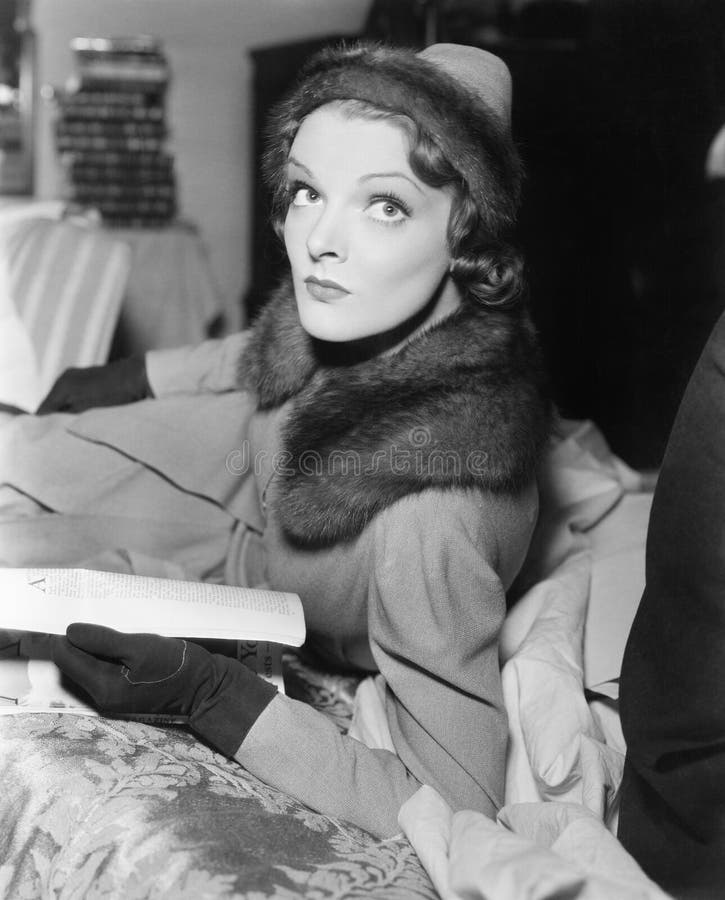 Woman in coat and hat reading a magazine royalty free stock photos Woman in coat and hat reading a magazine royalty free stock photos