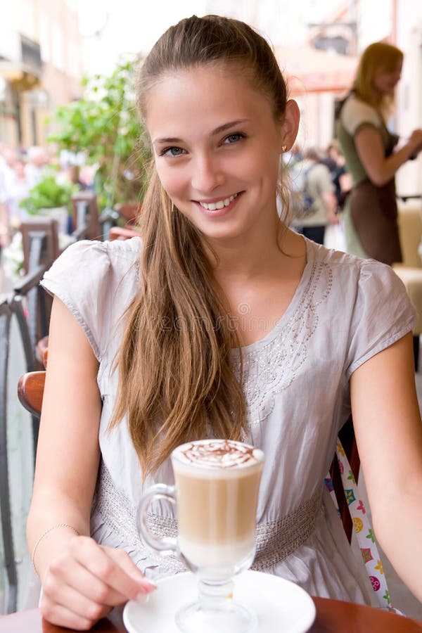 Woman with coffee in cafe