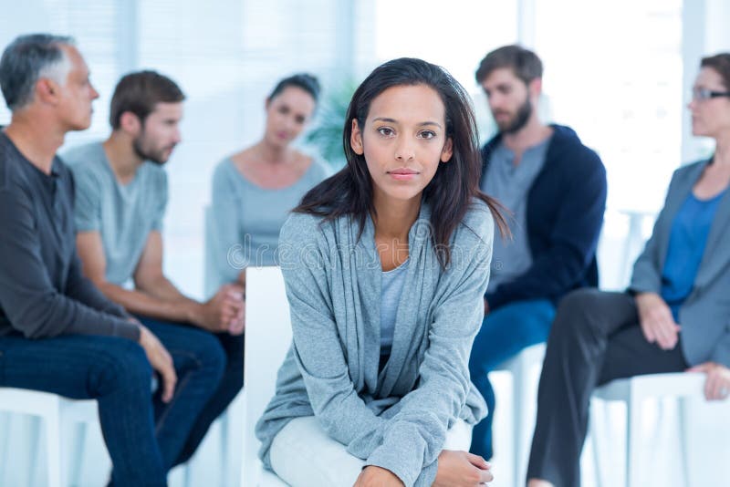 Woman comforting another in rehab group at a therapy session. Woman comforting another in rehab group at a therapy session