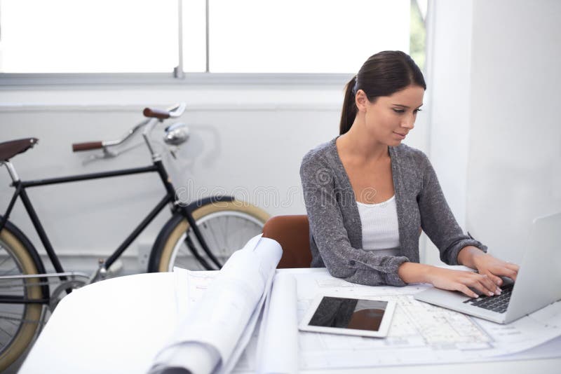Woman, computer and blueprint for architecture, construction and design planning in a startup office. Young engineering stock images