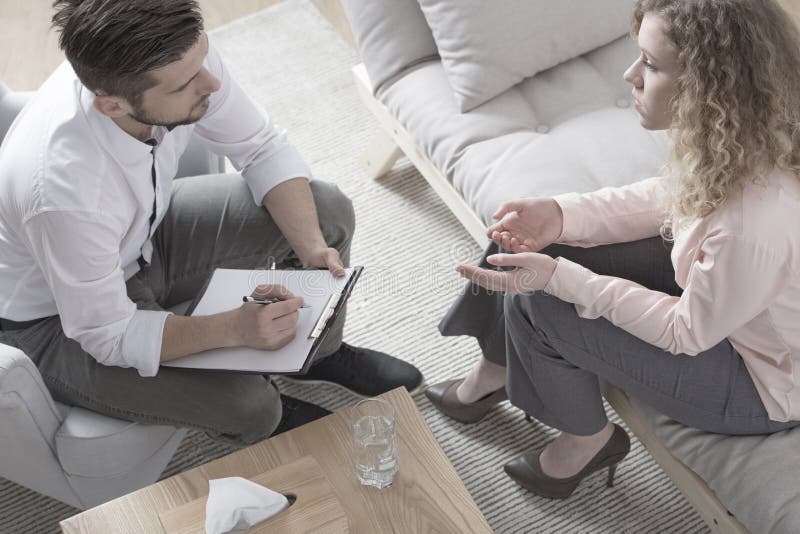 High angle of a women consulting with a divorce lawyer. High angle of a women consulting with a divorce lawyer