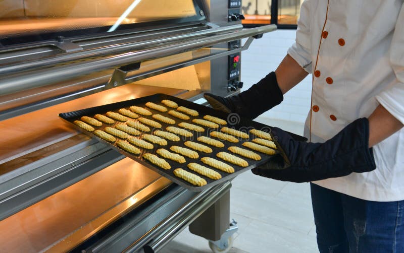 Puts Cakes in the Oven at Bakery Stock Photo - Image of bakingdish ...