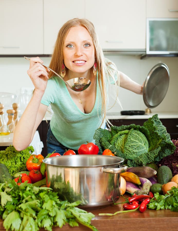 Woman cooking with ladle in home royalty free stock images
