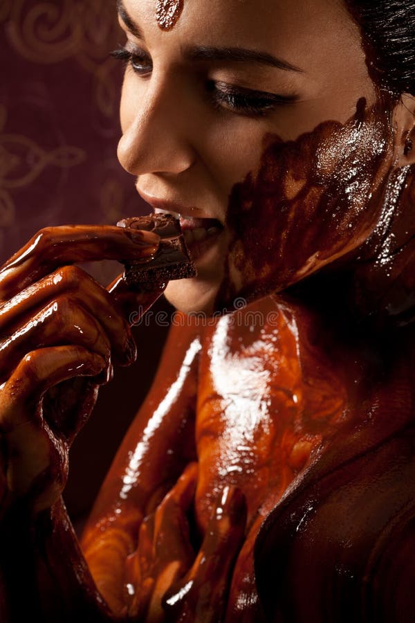 Woman covered in melted chocolate