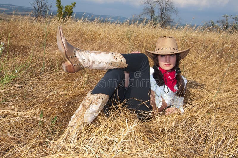 Woman cowboy relax in a field