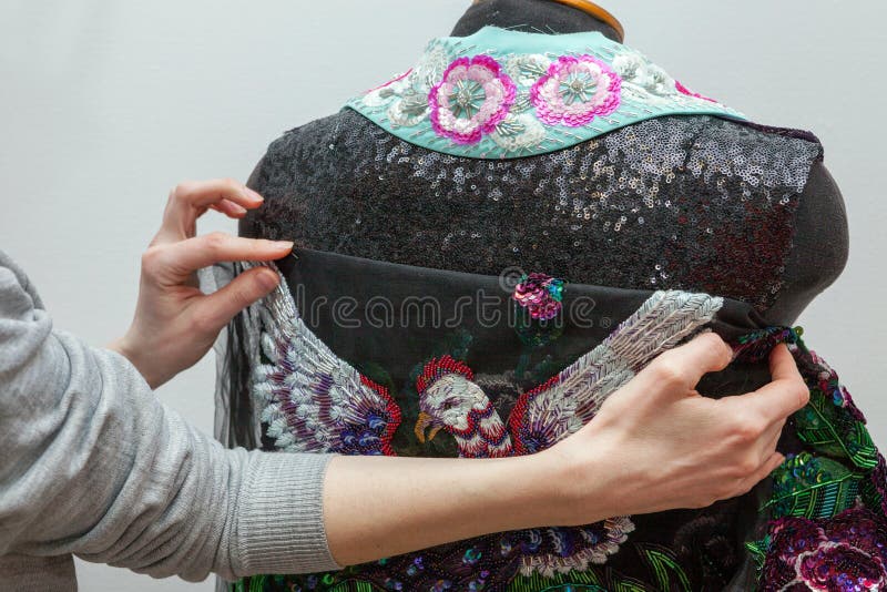 A woman creates exclusive clothes. stock photo