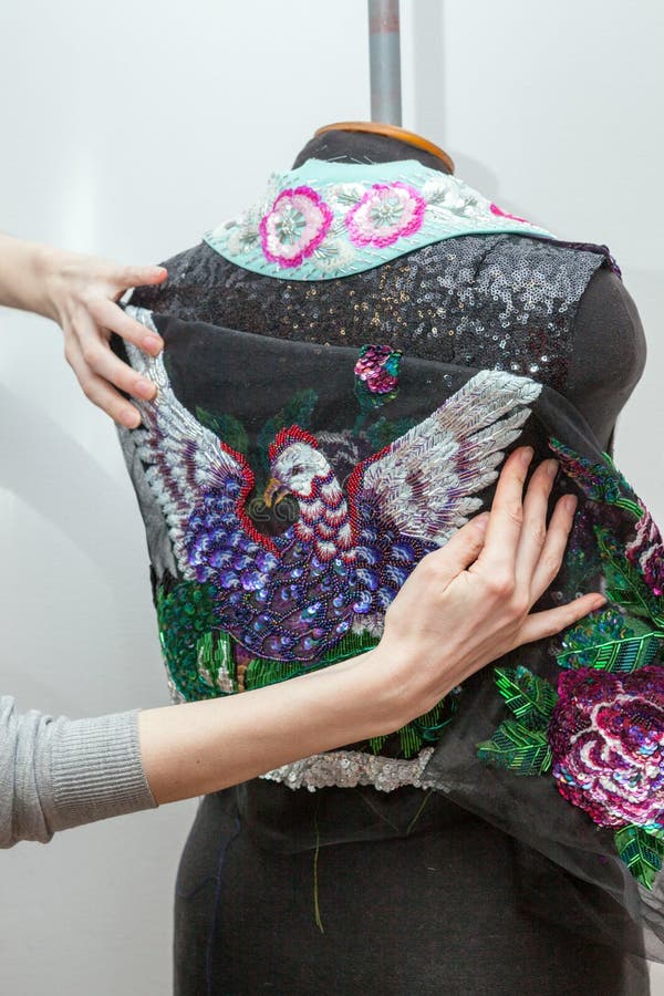 A woman creates exclusive clothes. royalty free stock image