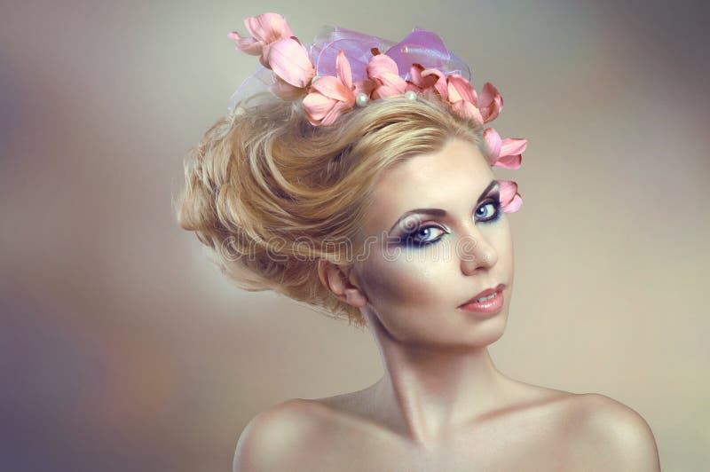 Woman with creative hairstyle with flowers