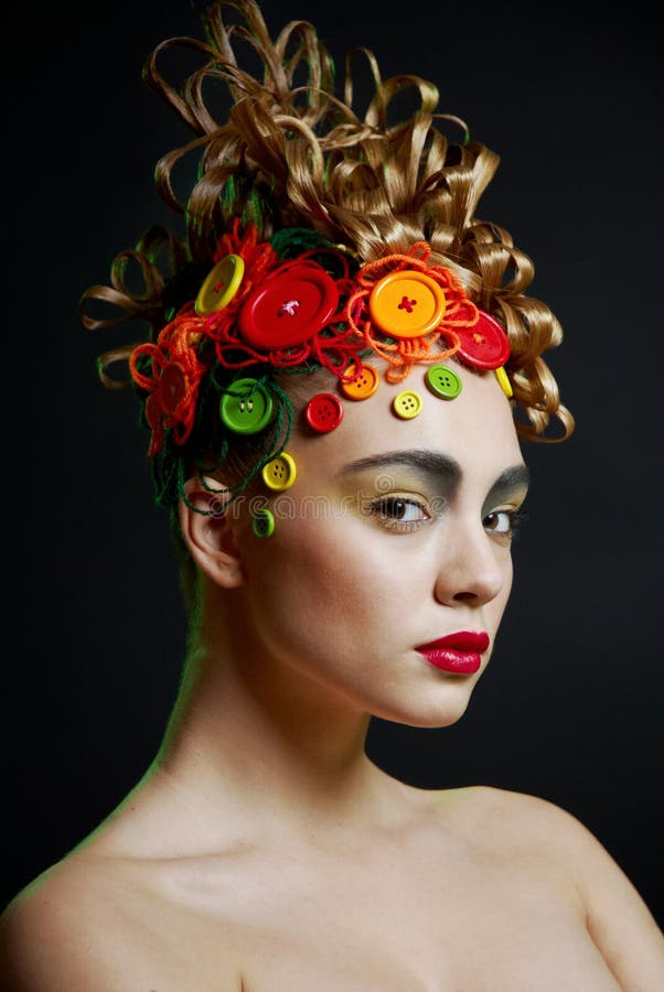 Woman with creativity hairstyle with colored butto