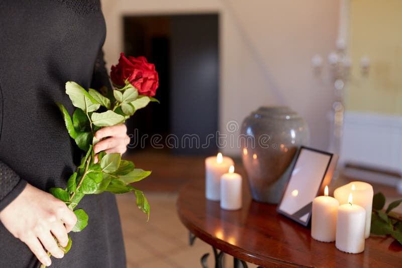 Woman with cremation urn at funeral in church