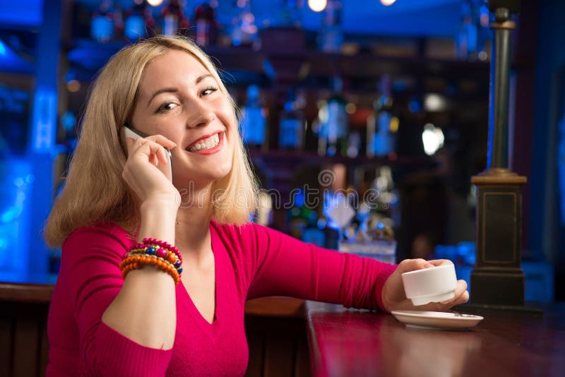 Woman with a cup of coffee and cell phone stock photography Woman with a cup of coffee and cell phone stock photography