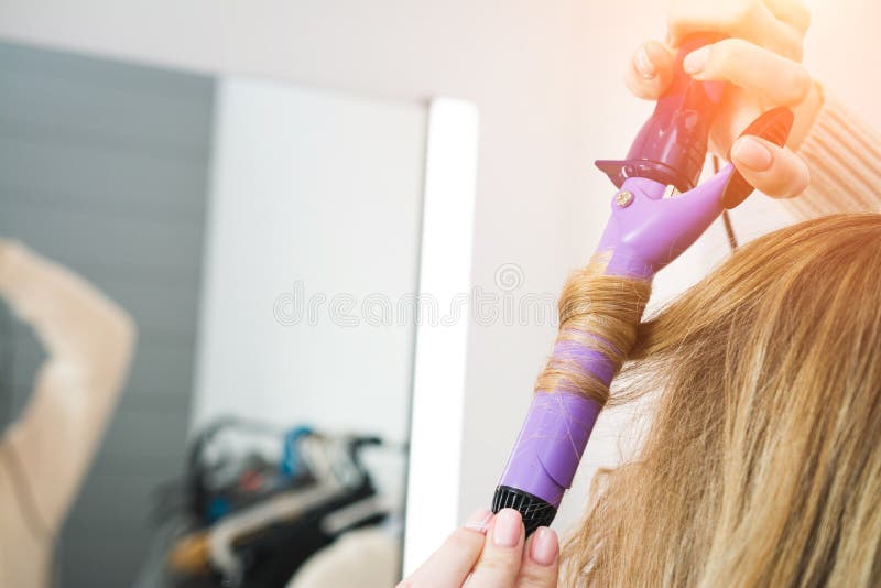 Woman curls her hair royalty free stock photo Woman curls her hair royalty free stock photo