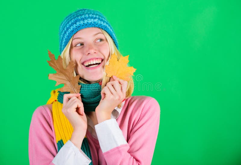 Woman cute face wear knitted hat hold fallen leaves. Time to rejuvenate and repair skin. Healthy skin. How to update stock image Woman cute face wear knitted hat hold fallen leaves. Time to rejuvenate and repair skin. Healthy skin. How to update stock image