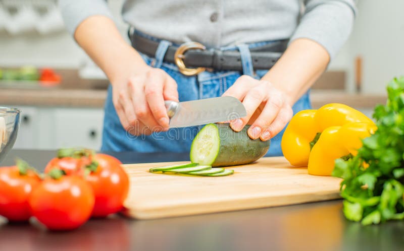 Woman is Cutting Cucumber on Cut Board on Kitchen Stock Photo - Image ...