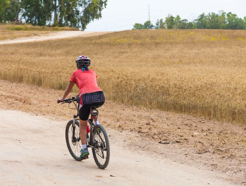 Woman cyclist riding on the road