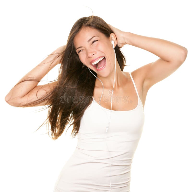 Music. Woman dancing with earbuds / headphones listening to music on mp3 player. Playful happy smiling young mixed race Asian Caucasian woman isolated on white background. Music. Woman dancing with earbuds / headphones listening to music on mp3 player. Playful happy smiling young mixed race Asian Caucasian woman isolated on white background.